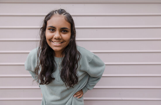 Portrait of young Aboriginal woman leaning forward