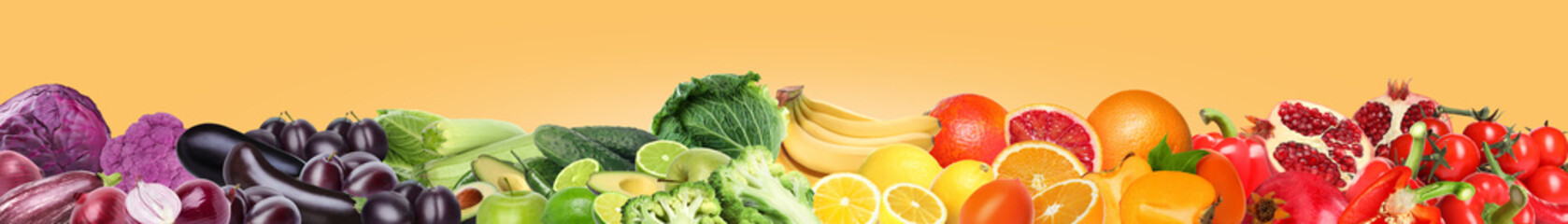 Many different fresh fruits and vegetables on pale orange background. Banner design