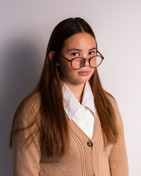sky teen girl wearing a cardigan and glasses