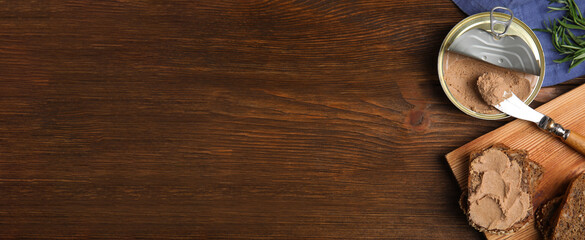 Tin can with delicious pate and slices of bread on wooden table, flat lay. Banner design with space...