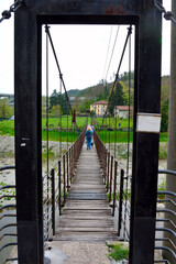 walkway bridge over the river bormida millesimo savona italy