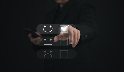 Concept of satisfaction and customer service. : Business man use his finger to touching or pressing the virtual screen the smiley happy face to show satisfaction with the service or give rate.	