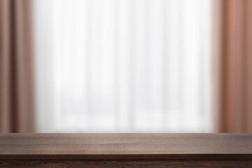 Empty wooden table against window with curtains. Space for design