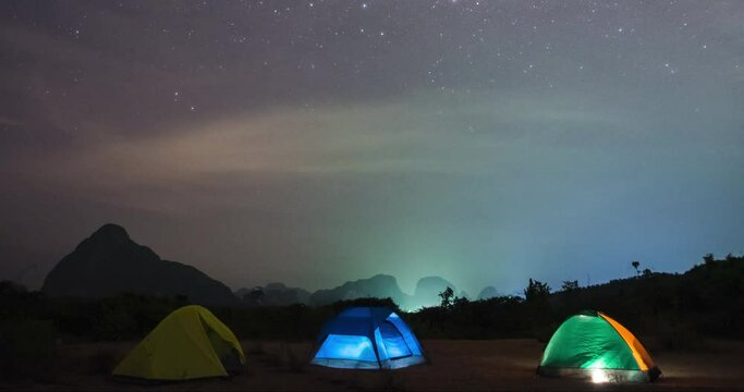 tourist tent in a meadow against the background of mountain smed nangshe peaks and the Milky Way in the night sky