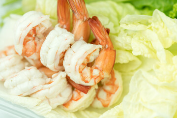 Steamed peeled shrimps on fresh lettuce. Selective focus