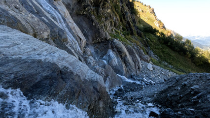 Fototapeta na wymiar beautiful mountain highland fast water cascade at summer day - photo of nature