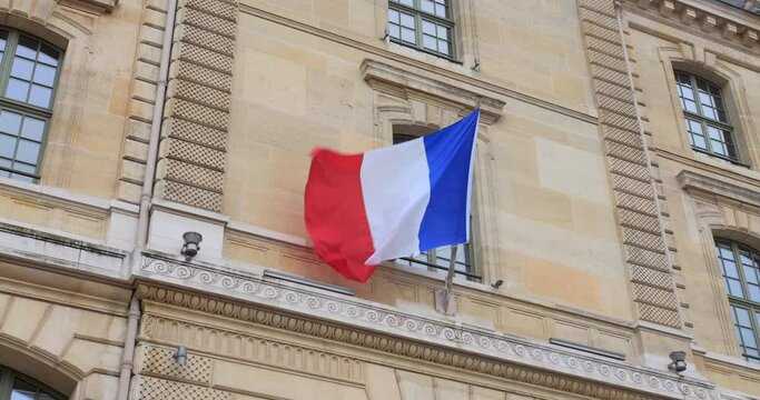 Scenic View Of Waving French Flag On Pole At A Parisian Building In Paris, France. low-angle, close-up