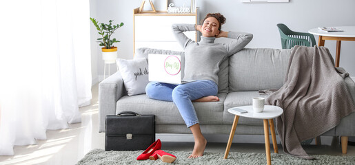 Young businesswoman relaxing on sofa before weekends at home