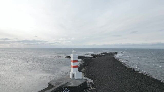 North head lighthouse at a headland at sunset on the extreme west side of Iceland