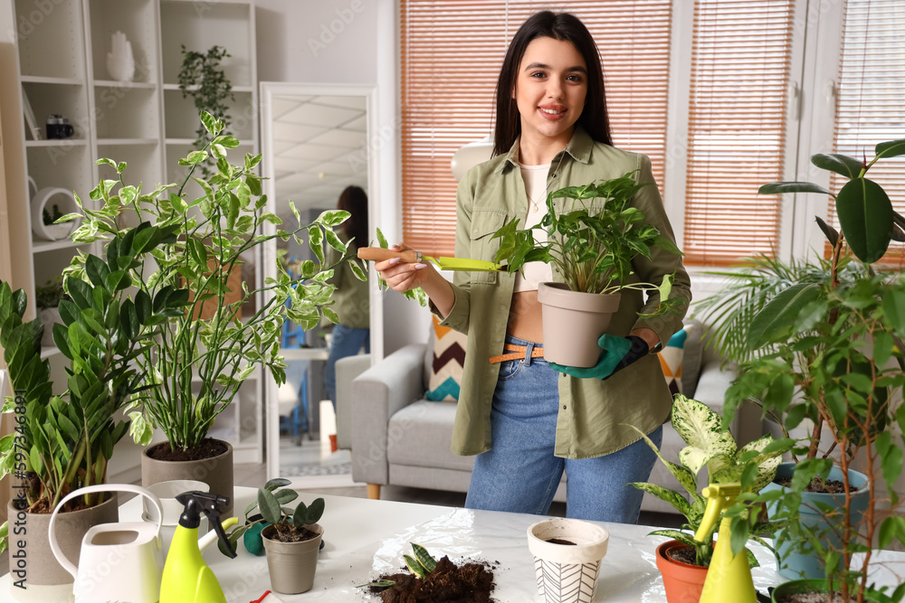 Poster young woman with shovel and green houseplants at home