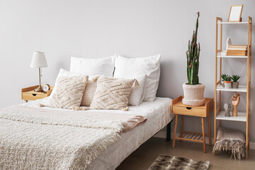 Fototapeta na wymiar Interior of cozy bedroom with big cactus in pot