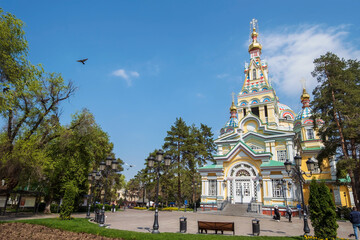 Almaty, Kazakhstan - April 2023: Christian Voznesenskiy Cathedral in the center of Almaty city. Orthodox christian church. Panfilov park. High quality exterior photo.