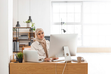 Arabian female programmer working in office - Powered by Adobe