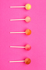 Sweet lollipops on pink background