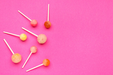Sweet lollipops on pink background