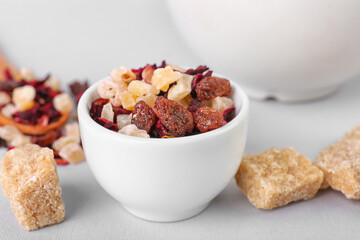 Bowl with dried fruit tea and snacks isolated on white background