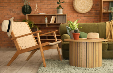 Fototapeta na wymiar Interior of stylish living room with green sofa, armchair and coffee table
