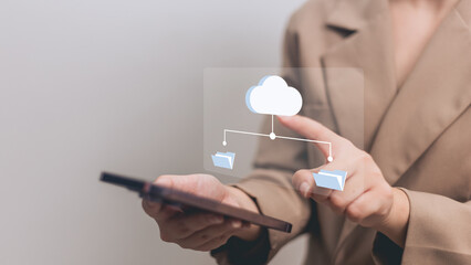 Businesswoman using smartphone with cloud storage icon on screen, closeup