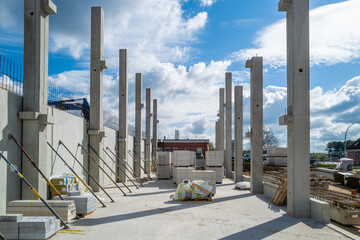 concrete pillars for a factory building are erected on a construction site