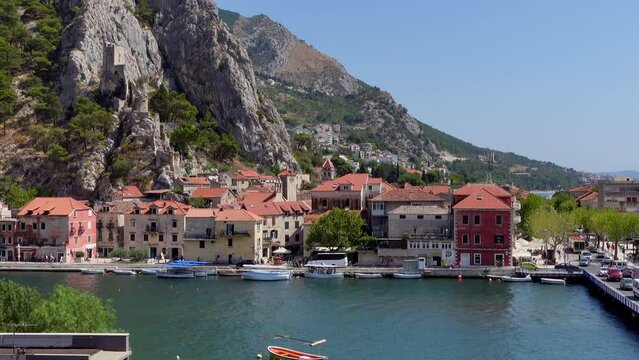 Static shot of a bridge over the Cetina River in Omis, Croatia, with the mountains in the background.
