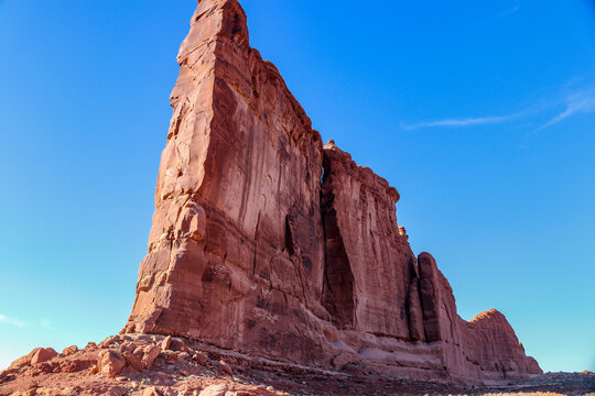 Massive sandstone rock fins stand tall against the blue sky at the Arches National Park in Moab Utah.
