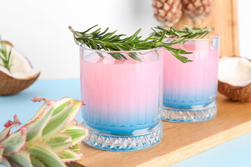Glasses of cocktail with rosemary on board, closeup