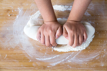 Hands Kneading Dough with Flour on Wooden Board for Homemade Baking Preparation