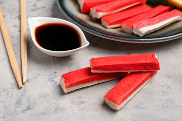Tasty crab sticks with sauce on grunge background © Pixel-Shot