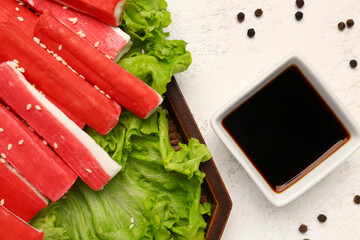 Plate with tasty crab sticks and sauce on light background, closeup © Pixel-Shot