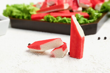 Tasty cut crab sticks on light background © Pixel-Shot