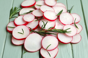 Slices of fresh radish on wooden table