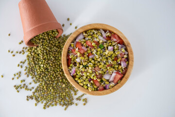 Sprouting green gram bean Indian salad with Onion, coriander leaf , green chili and tomatoes. Indian sprouting gram bean salad with isolated background.