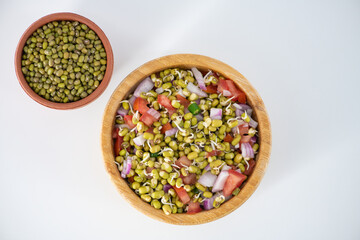 Sprouting green gram bean Indian salad with Onion, coriander leaf , green chili and tomatoes. Indian sprouting gram bean salad with isolated background.