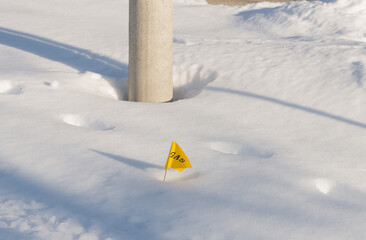 Gas supply pipeline marker / flag on a snowy ground