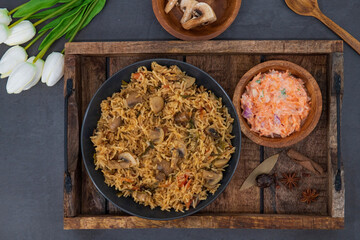 Tasty Mushroom or Mashroom Rice or Pulav or Pilaf or Pulao or Biryani served in bowl or plate. Delicious Mushroom fried rice with isolated background. Also called Kaalan Biryani.