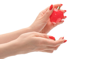Red bottle of perfume in woman hand with red nails isolated on a white background.