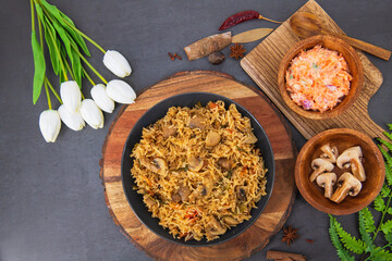 Tasty Mushroom or Mashroom Rice or Pulav or Pilaf or Pulao or Biryani served in bowl or plate. Delicious Mushroom fried rice with isolated background. Also called Kaalan Biryani...