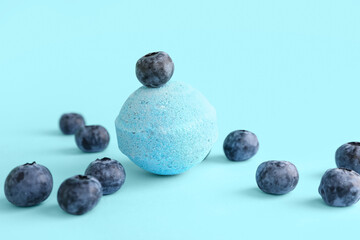 Bath bomb with blueberry on blue background