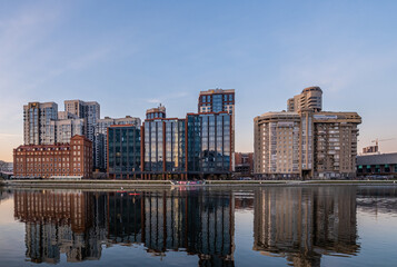 Reflection of new high-rise buildings in the river water.
