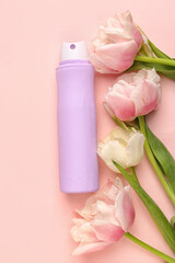 Obraz na płótnie Canvas Deodorant bottle and flowers on pink background