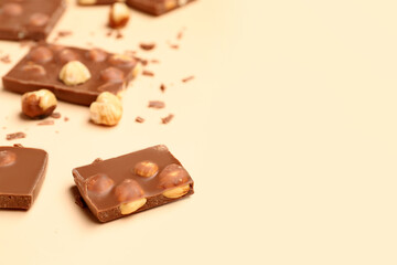 Sweet tasty chocolate with nuts on  beige background