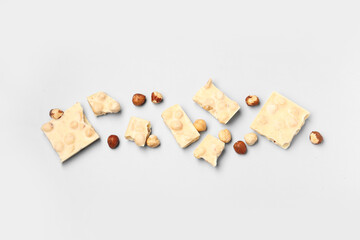 Sweet white chocolate with nuts on  light background