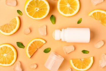 Deodorant with lemon slices, ice and mint on orange background