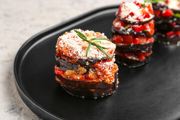 Tray with tasty baked Eggplant Parmesan on table, closeup