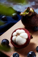 mangosteen(Garcinia mangostana),on kitchen wooden table top, dark background