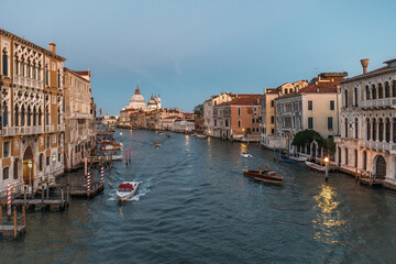 Fototapeta na wymiar Stunning panoramic view from above on the Grand Canal in Venice on a cloudless warm summer evening. The concept of a honeymoon romantic trip in Europe. Copyspace