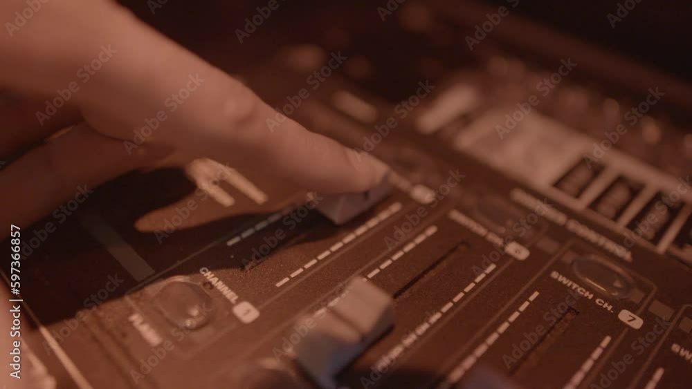 Poster close up of a hand moving a slider button to control the lights in a nightclub log