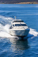 Fototapeta premium Motorboat traveling at the coastline