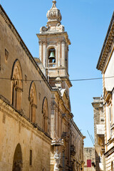 Fototapeta na wymiar City of Mdina, former capital of Malta, with clock tower of Chapel of St. Roque also know as Chapel of Our Lady of Light on a hot summer day. Photo taken August 8th, 2017, Mdina, Malta.