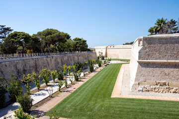 City wall with moat at City of Mdina, former capital of Malta, on a hot summer day. Photo taken...